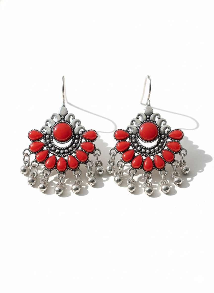 Pair of red and silver earrings on a white background