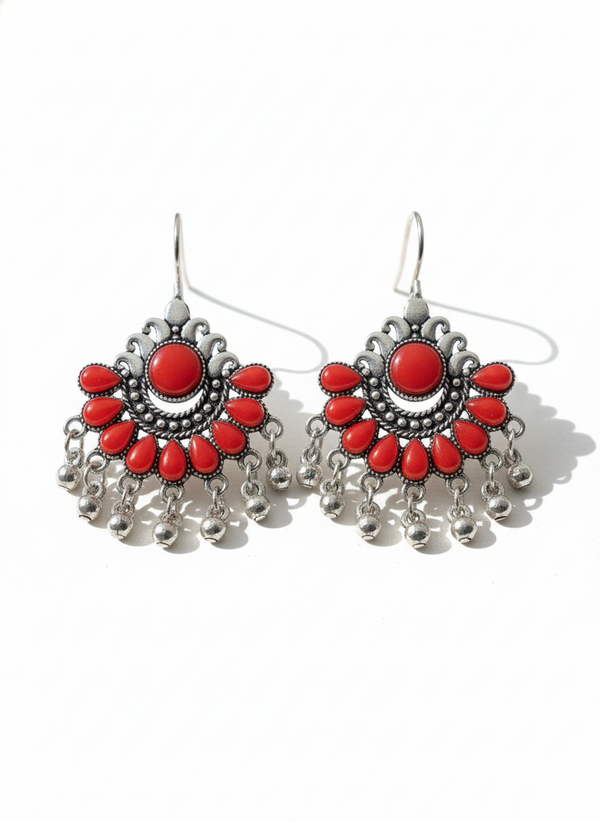 Pair of red and silver earrings on a white background