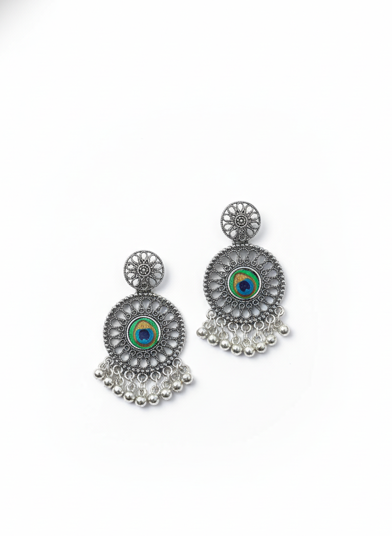 Ornate earrings with circular designs and dangling elements on a white background