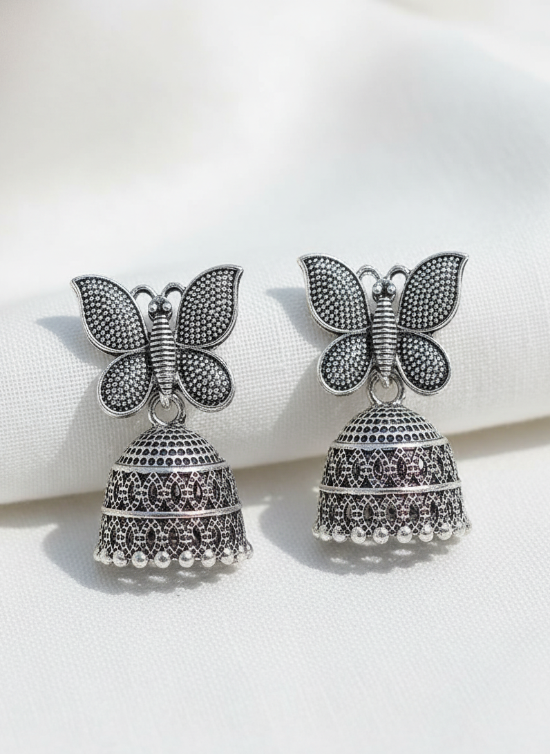 Butterfly-shaped earrings with bell-like designs on a white background