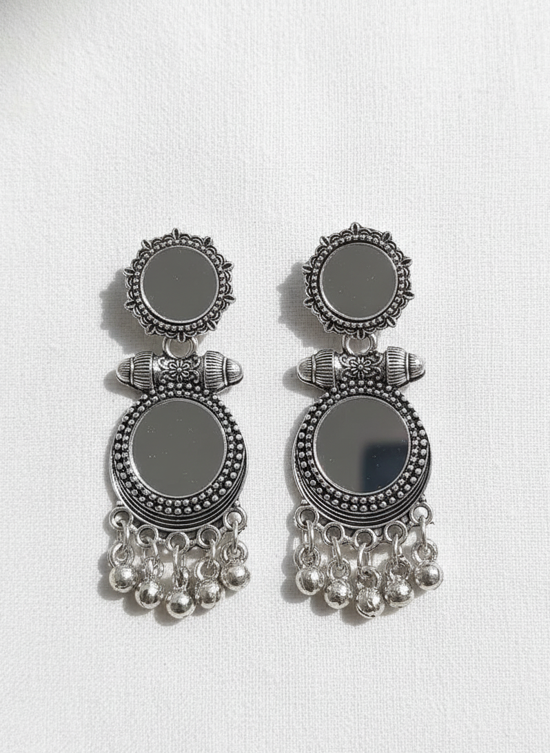 Pair of silver earrings with black stones on a white background