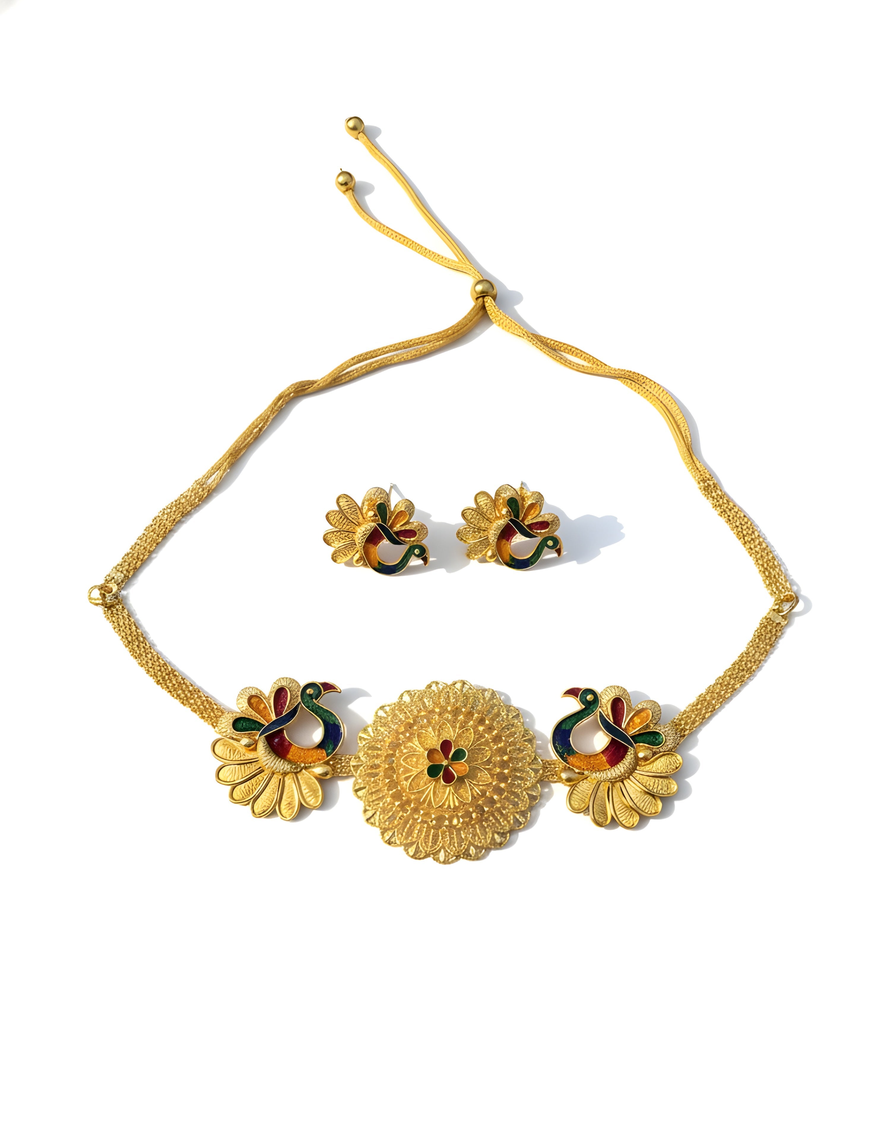 Gold necklace and earrings set on a white background