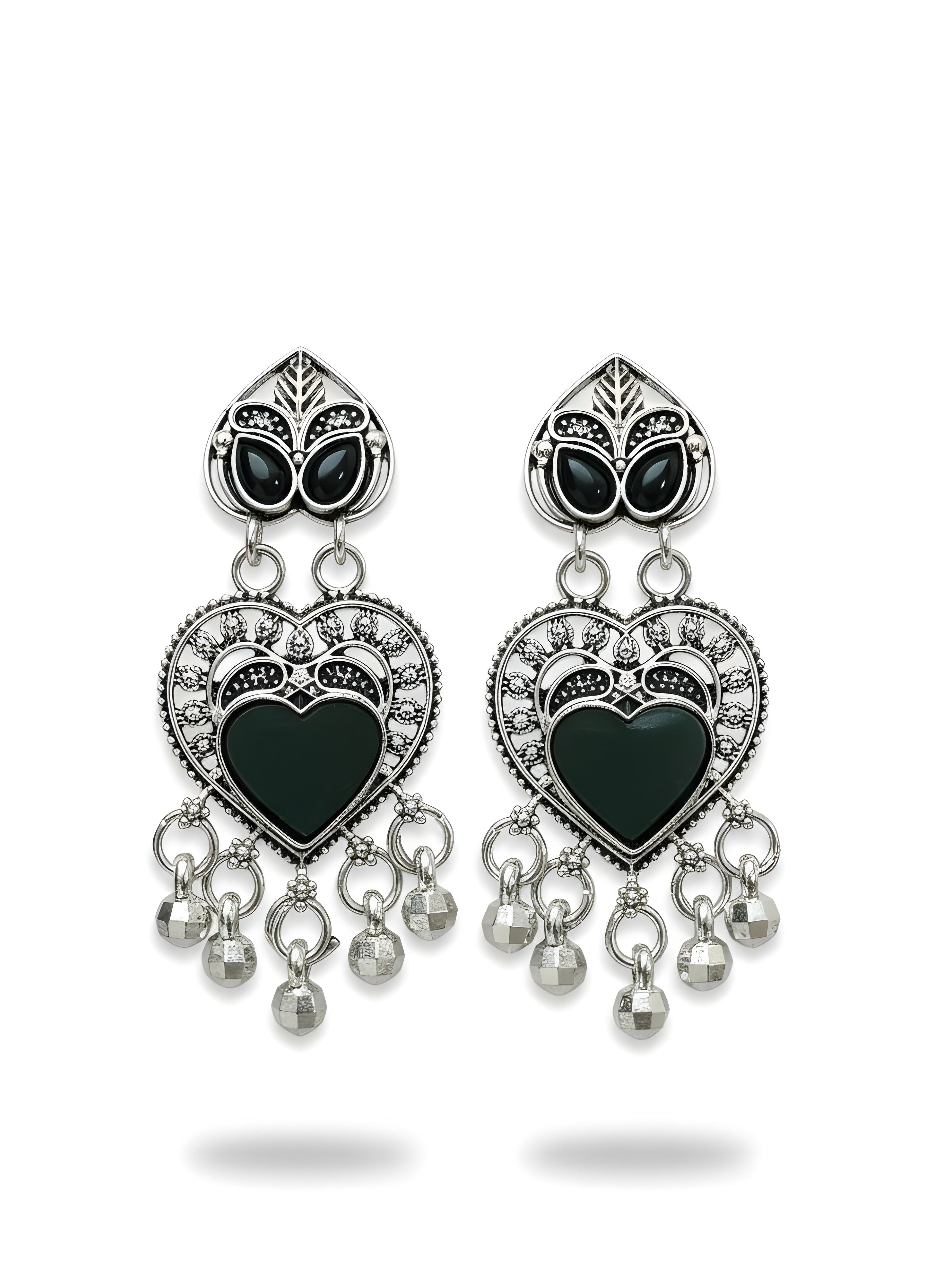 Pair of heart-shaped earrings with black centers and silver accents on a white background
