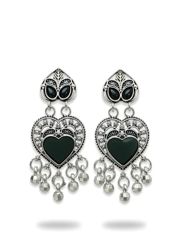 Pair of heart-shaped earrings with black centers and silver accents on a white background