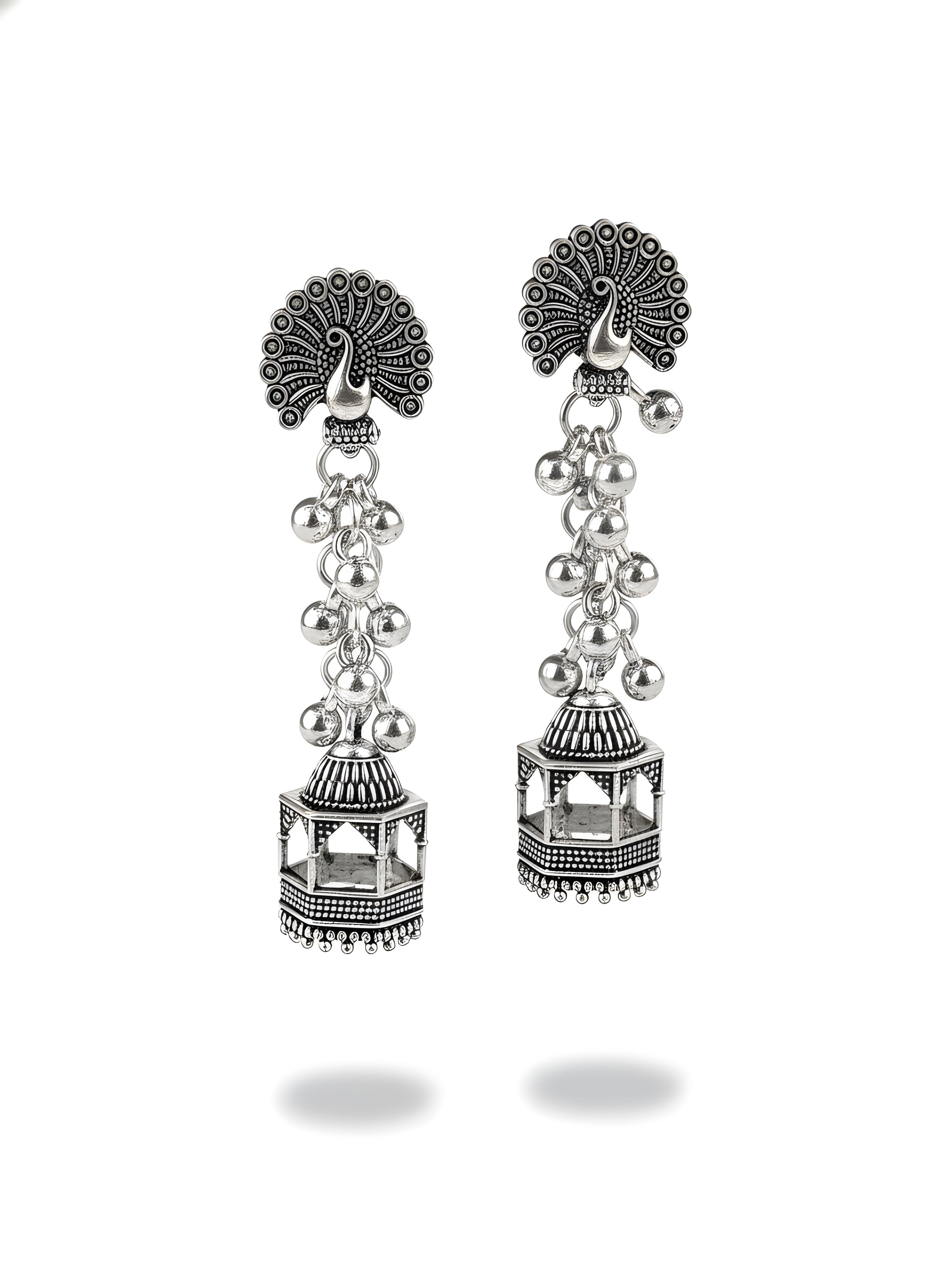 Pair of silver earrings with intricate designs on a white background