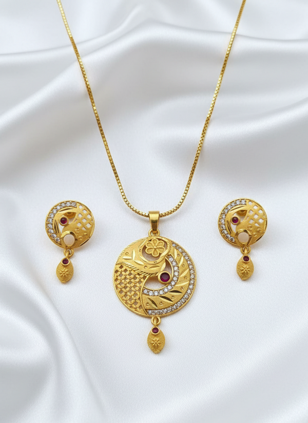 Gold necklace and earrings set on a white fabric background