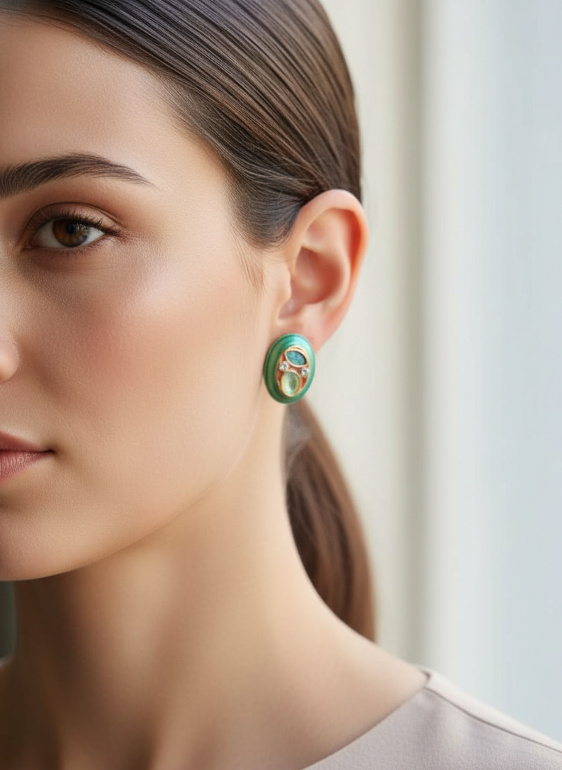 Close-up of a woman wearing green earrings with a neutral background