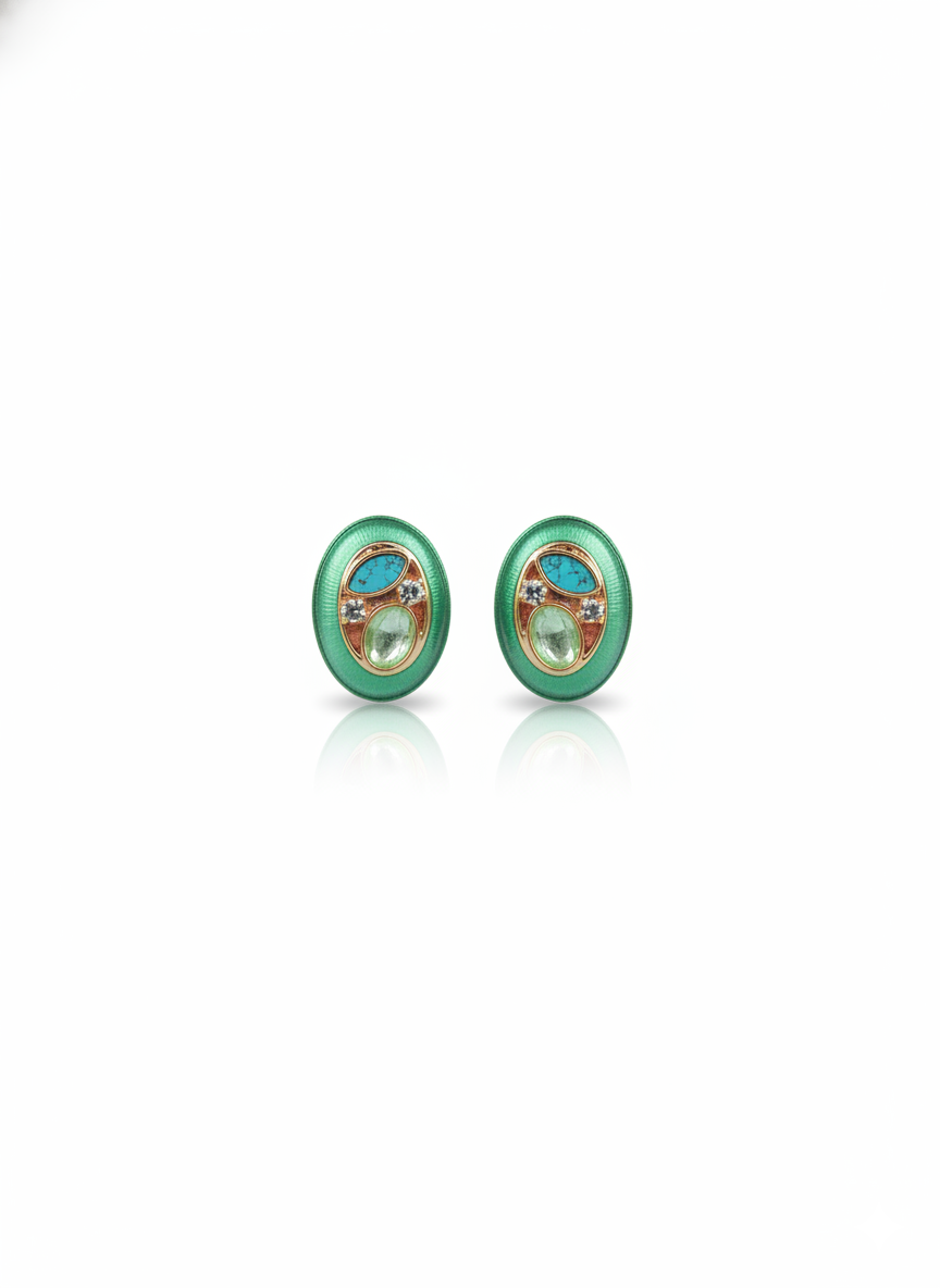 Pair of green earrings with circular design on a white background