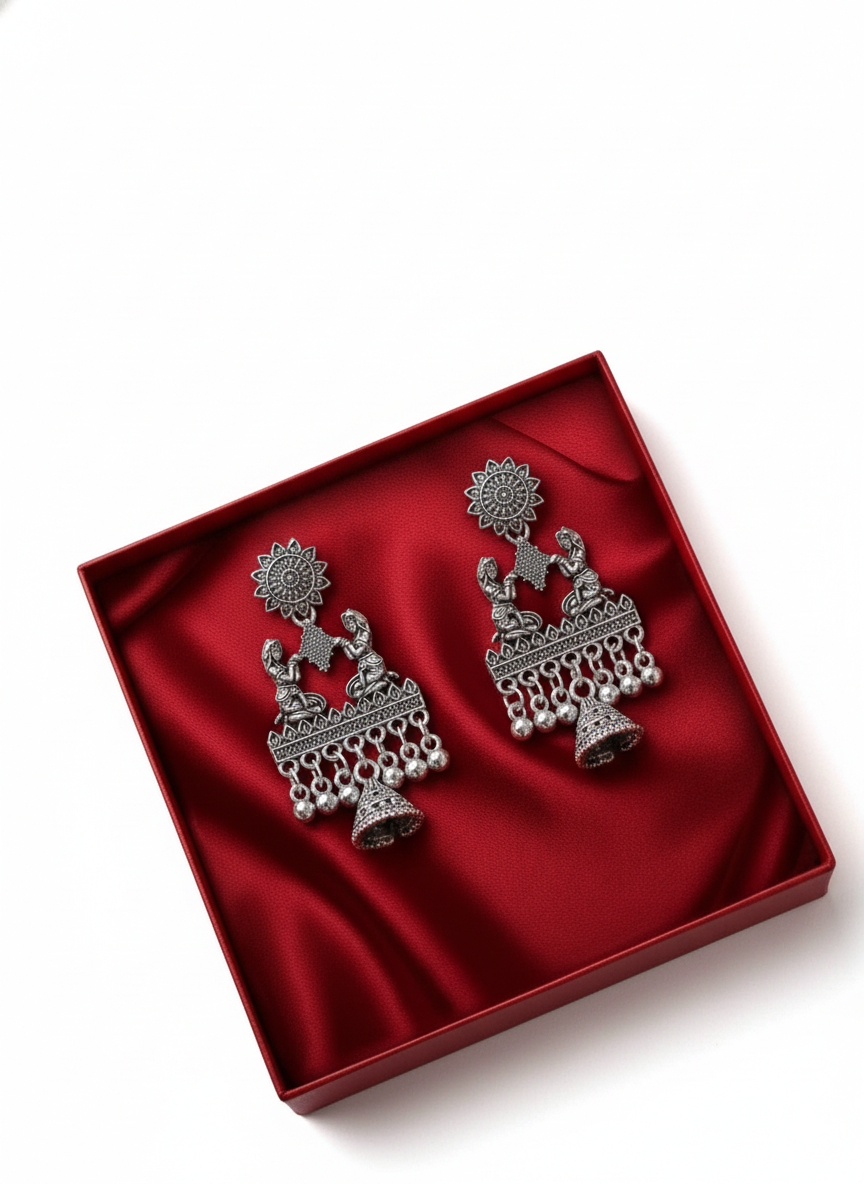 Pair of silver earrings in a red box on a white background
