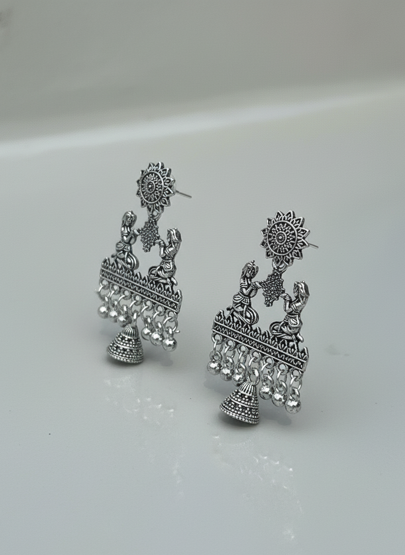 Pair of silver earrings on a light gray background