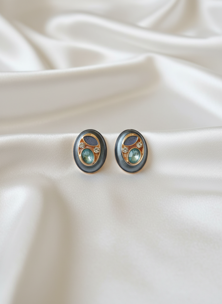 Pair of earrings on a white fabric background